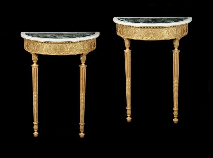 A PAIR OF GEORGE III DEMI-LUNE GILTWOOD CONSOLE TABLES